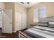 Comfortable bedroom featuring wood floors, a ceiling fan, and sliding closet doors at 4834 E Robin Ln, Phoenix, AZ 85054