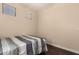 Neutral-toned bedroom with hardwood floors and a window bringing in natural light at 4834 E Robin Ln, Phoenix, AZ 85054