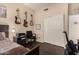 Bedroom with guitars on the wall above a work area adjacent to the bed at 4834 E Robin Ln, Phoenix, AZ 85054