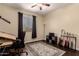 Cozy room with a ceiling fan, decorative rug, and a collection of guitars at 4834 E Robin Ln, Phoenix, AZ 85054