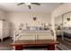 This bedroom features a queen bed, dark wood floors, ceiling fan, and white furniture at 4834 E Robin Ln, Phoenix, AZ 85054