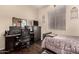 Bedroom featuring a workspace and bed with dark wood floors and natural light at 4834 E Robin Ln, Phoenix, AZ 85054