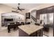 Open kitchen with stainless steel fridge, island, and views into dining and living areas at 4834 E Robin Ln, Phoenix, AZ 85054