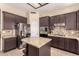 Charming kitchen with stainless steel appliances, granite countertops, and dark wood cabinetry at 4834 E Robin Ln, Phoenix, AZ 85054