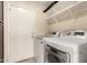 Laundry room featuring washer, dryer, and shelving for storage at 4834 E Robin Ln, Phoenix, AZ 85054