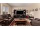 Living room with entertainment center, leather furniture, and area rug at 4834 E Robin Ln, Phoenix, AZ 85054