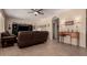Bright and spacious living room with a brown leather sofa, desk, and neutral color palette at 4834 E Robin Ln, Phoenix, AZ 85054