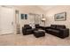Living room featuring leather couches and tile floors at 4834 E Robin Ln, Phoenix, AZ 85054