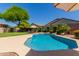 Backyard pool surrounded by lush landscaping and a patio area at 4834 E Robin Ln, Phoenix, AZ 85054