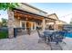The covered patio provides plenty of shade for outdoor seating or dining near the built-in outdoor kitchen at 5443 W Hobby Horse Dr, Phoenix, AZ 85083