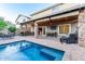 Inviting backyard pool and patio area with an outdoor kitchen, bar, and comfortable seating at 5443 W Hobby Horse Dr, Phoenix, AZ 85083