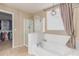 Bathroom showing soaking tub and glass enclosed shower with access to walk-in closet at 5443 W Hobby Horse Dr, Phoenix, AZ 85083