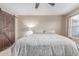 Bedroom features a ceiling fan and a barn-style door to the ensuite bathroom at 5443 W Hobby Horse Dr, Phoenix, AZ 85083