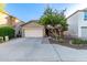 Well-maintained home exterior with a spacious driveway and mature landscaping at 5443 W Hobby Horse Dr, Phoenix, AZ 85083