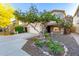 Beautiful home exterior with desert landscaping, mature trees, and a two-car garage at 5443 W Hobby Horse Dr, Phoenix, AZ 85083