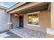 Covered front porch featuring brick pavers and a secure screen door at 5443 W Hobby Horse Dr, Phoenix, AZ 85083