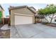 Home exterior showcasing the two-car garage and manicured front yard desert landscaping at 5443 W Hobby Horse Dr, Phoenix, AZ 85083