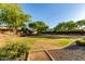 Large, grassy community green space with mature shade trees and landscaping at 5443 W Hobby Horse Dr, Phoenix, AZ 85083