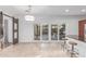 Bright kitchen and dining area featuring tile floors, stylish chandelier and sliding doors to patio at 5443 W Hobby Horse Dr, Phoenix, AZ 85083