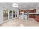 Spacious kitchen with stainless steel appliances, dark granite counters, and sliding glass doors to outdoor area at 5443 W Hobby Horse Dr, Phoenix, AZ 85083
