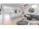 Bright open living room with a modern ceiling fan and pendant chandelier at 5443 W Hobby Horse Dr, Phoenix, AZ 85083