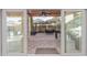 View of a covered outdoor patio through sliding glass doors with grill and outdoor seating at 5443 W Hobby Horse Dr, Phoenix, AZ 85083