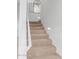 Carpeted staircase with white railing and built-in lights for an illuminated path at 5443 W Hobby Horse Dr, Phoenix, AZ 85083