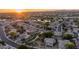 Scenic aerial view of a residential neighborhood with tree-lined streets and a picturesque lake at sunset at 6172 W Kerry Ln, Glendale, AZ 85308