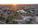 Aerial view of community park featuring playgrounds, courts, and open spaces at sunset at 6172 W Kerry Ln, Glendale, AZ 85308