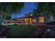 Expansive backyard showcasing a lush lawn, inviting pool, covered patio, and well-lit exterior, ideal for outdoor enjoyment at 6172 W Kerry Ln, Glendale, AZ 85308