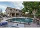 A private backyard features a refreshing pool, manicured lawn, and covered patio, perfect for outdoor entertaining at 6172 W Kerry Ln, Glendale, AZ 85308