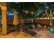 Lush backyard featuring a well-maintained lawn, lounge chairs, and a serene pool area enhanced by string lights at 6172 W Kerry Ln, Glendale, AZ 85308