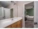 Clean bathroom featuring a single sink vanity and doorway leading to another bedroom at 6172 W Kerry Ln, Glendale, AZ 85308