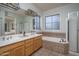 Bright bathroom featuring a bathtub, dual vanity and a stand up shower at 6172 W Kerry Ln, Glendale, AZ 85308