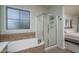 Bathroom with a soaking tub and glass enclosed shower at 6172 W Kerry Ln, Glendale, AZ 85308