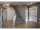 Spacious foyer with tile flooring, a white front door, and staircase to the second floor at 6172 W Kerry Ln, Glendale, AZ 85308