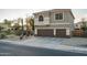 This home's exterior has a well-maintained three-car garage and desert landscaping at 6172 W Kerry Ln, Glendale, AZ 85308