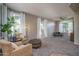 Comfortable living room featuring neutral tones, plush carpet, and large windows at 6172 W Kerry Ln, Glendale, AZ 85308