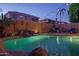 Inviting pool featuring a rock waterfall, string lights, and lush greenery, perfect for relaxation and backyard ambiance at 6172 W Kerry Ln, Glendale, AZ 85308