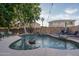 A sparkling pool and lush landscaping create a tranquil outdoor oasis for relaxation and entertainment at 6172 W Kerry Ln, Glendale, AZ 85308