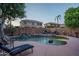 A luxurious pool has a rock waterfall feature and ample seating for relaxing and enjoying the serene outdoor space at 6172 W Kerry Ln, Glendale, AZ 85308