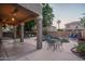 Outdoor patio area featuring a covered patio with a pool including a rock waterfall and ample seating, perfect for entertaining at 6172 W Kerry Ln, Glendale, AZ 85308