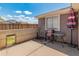 Cozy covered patio area with a table, chairs, and privacy fence at 6936 W Monterey Way, Phoenix, AZ 85033