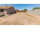 Large, private backyard enclosed by wood and concrete fencing offers ample space for various uses at 6936 W Monterey Way, Phoenix, AZ 85033