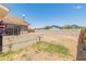 Spacious backyard featuring a concrete retaining wall and plenty of room for customization and enjoyment at 6936 W Monterey Way, Phoenix, AZ 85033