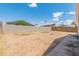 View of large, open backyard framed by the property's fence at 6936 W Monterey Way, Phoenix, AZ 85033