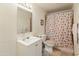 Bathroom featuring a vanity, toilet, mirror, and a seashell shower curtain at 6936 W Monterey Way, Phoenix, AZ 85033