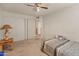 Bedroom with a ceiling fan and closet sliding doors at 6936 W Monterey Way, Phoenix, AZ 85033