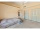 Bedroom featuring vaulted ceilings, a ceiling fan, carpet flooring, and walk in closets at 6936 W Monterey Way, Phoenix, AZ 85033