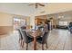 Dining room with table, seating for six, large window, and ceiling fan at 6936 W Monterey Way, Phoenix, AZ 85033